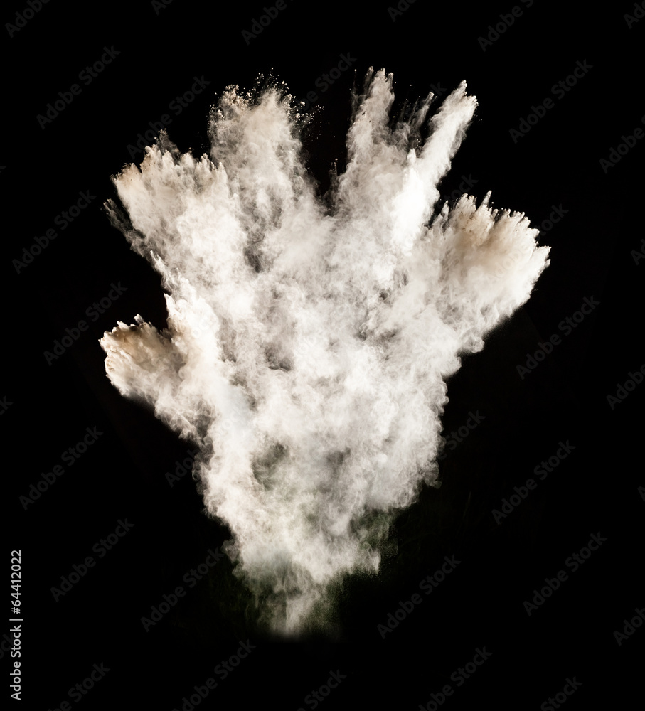 Fototapeta premium White dust explosions on black background
