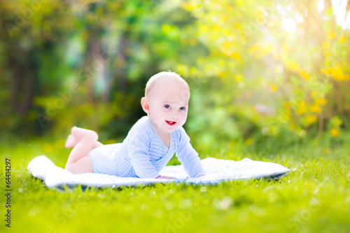 Cute laughing baby in the sunny garden