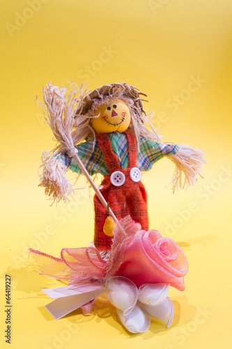 A funny colorful scarecrow with the flower