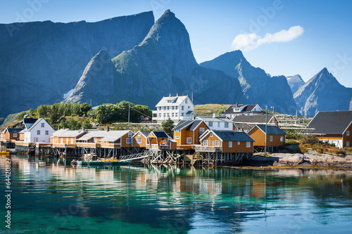 Typical Norwegian fishing village with traditional red rorbu hut photo