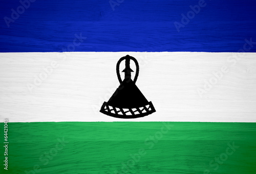 Lesotho flag on wood texture