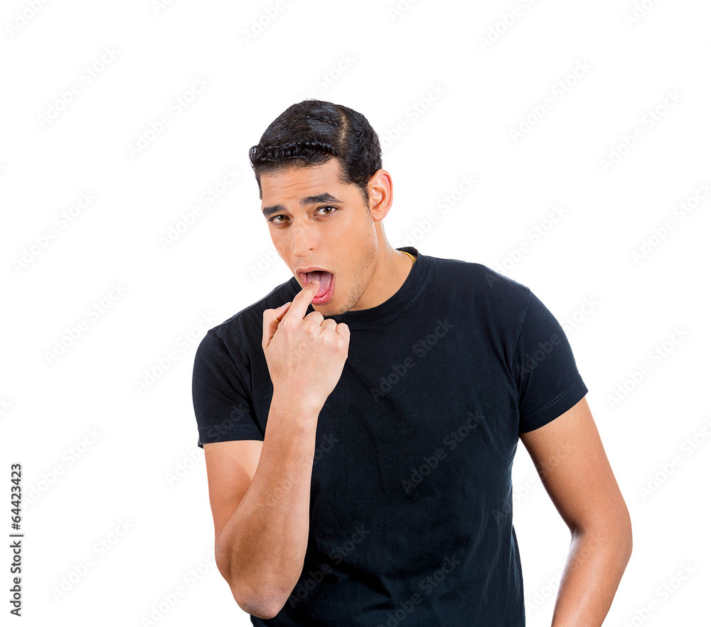 Disgust. young man sticking finger in mouth displeased Disgust. young man sticking finger in mouth displeased