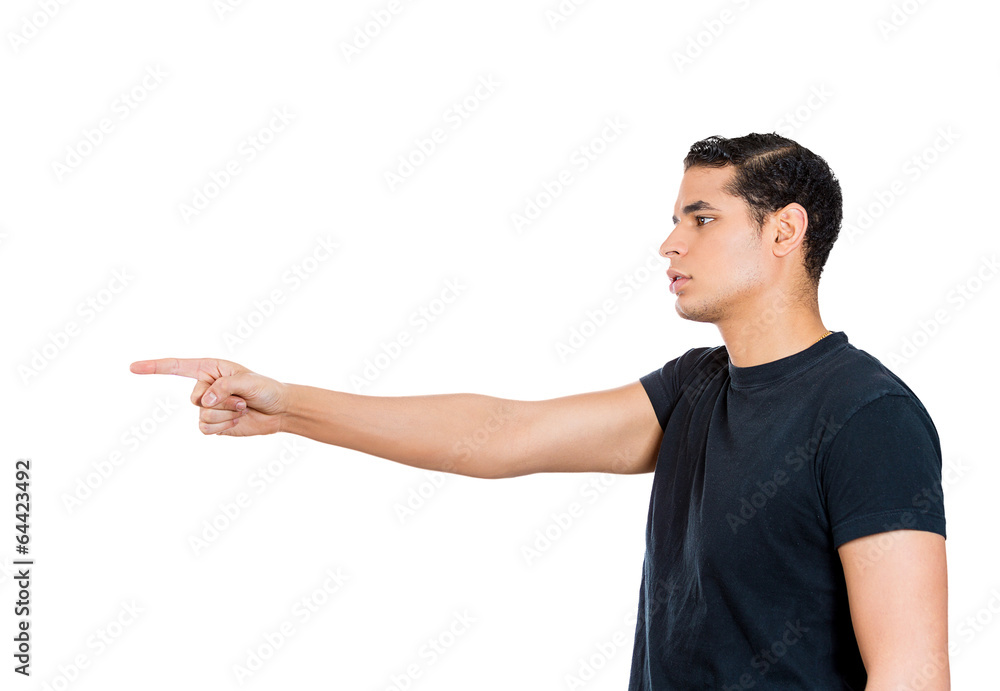 Serious young man pointing with index finger at someone Serious young man pointing with index finger at someone