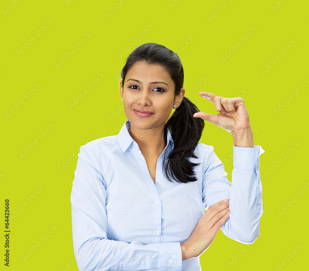 Woman showing small size hand gesture on green background Woman showing small size hand gesture on green background