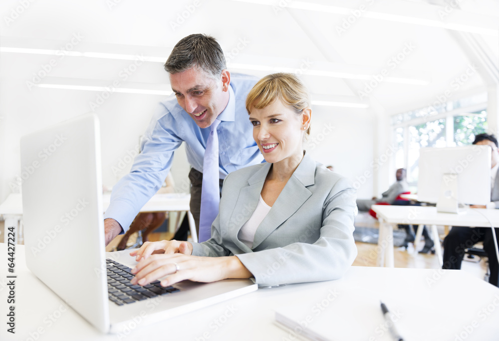 Boss Assisting Employee in Front of the Laptop Boss Assisting Employee in Front of the Laptop