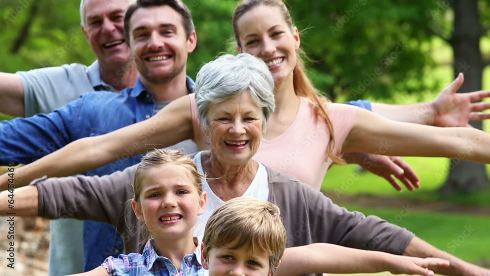 Extended family standing in the park together posing Extended family standing in the park together posing