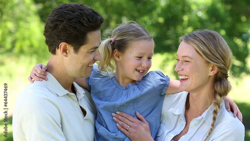 Happy parents with their little girl in the park Happy parents with their little girl in the park