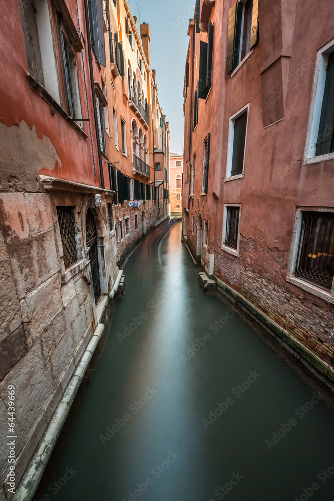 Narrow Canal Among Old Colorful Brick Houses in Venice, Italy Narrow Canal Among Old Colorful Brick Houses in Venice, Italy