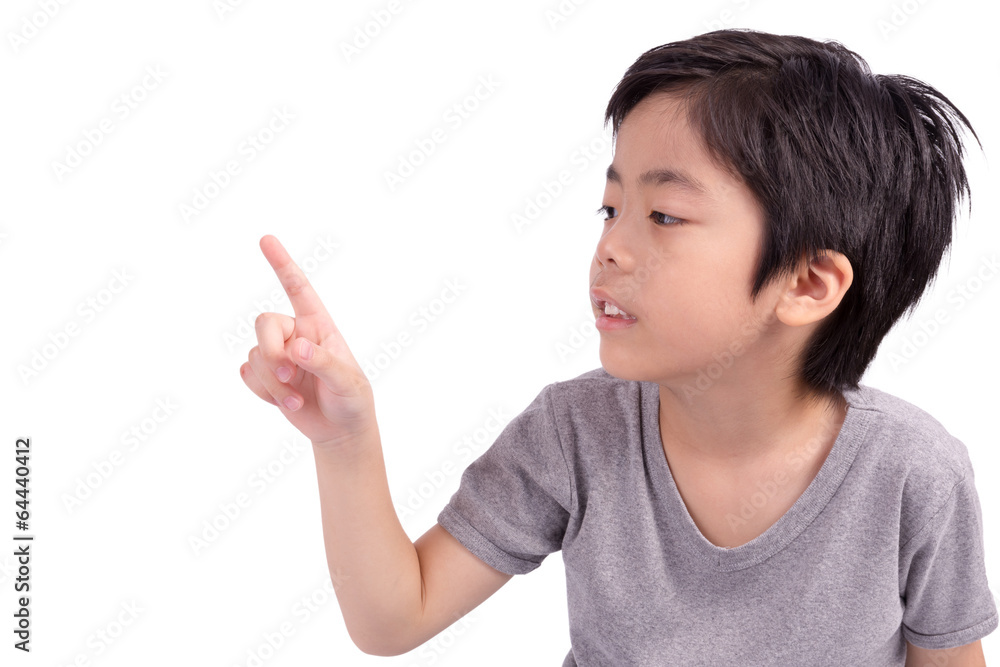 Happy boy pointing with his finger - isolated over a white backg Happy boy pointing with his finger - isolated over a white backg