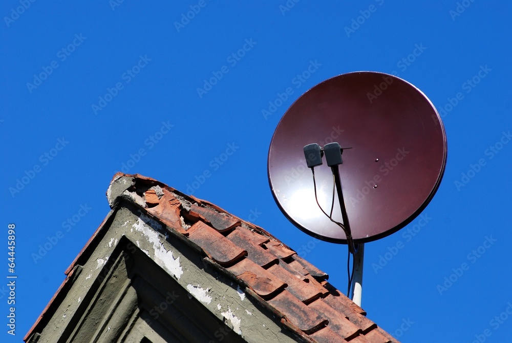 Satellite dish antenna on the old roof