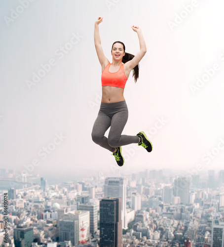 sporty teenage girl jumping in sportswear