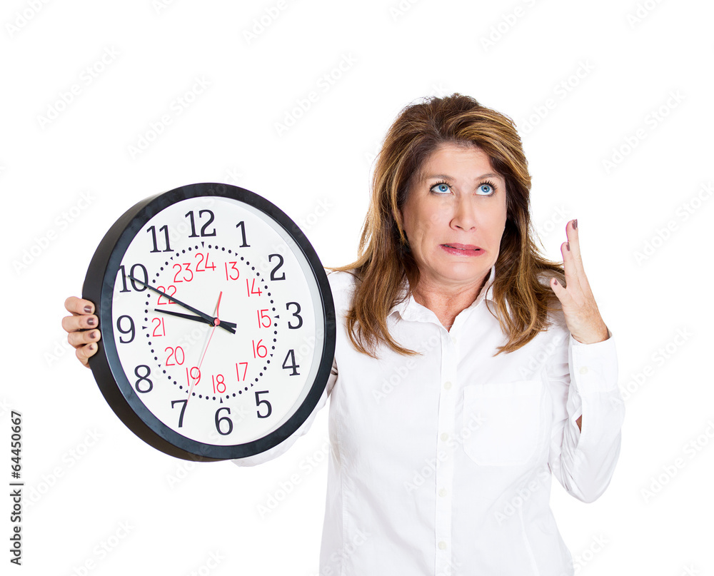 Running out of time.Stressed Businesswoman holding wall clock Running out of time.Stressed Businesswoman holding wall clock