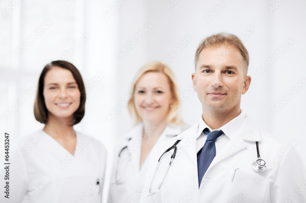 doctor with stethoscope and colleagues doctor with stethoscope and colleagues