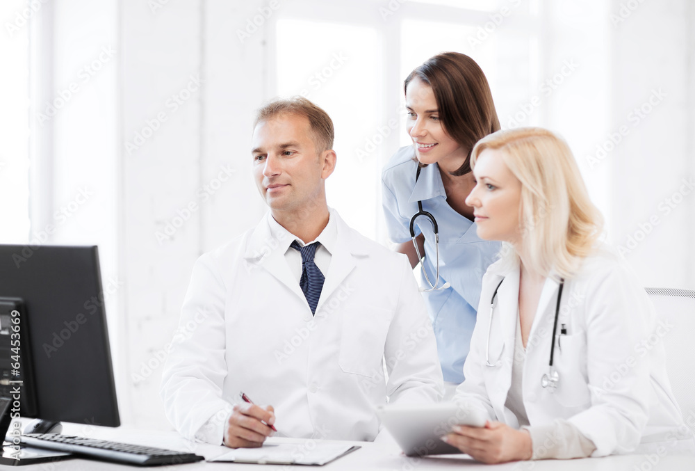 doctors looking at computer on meeting doctors looking at computer on meeting
