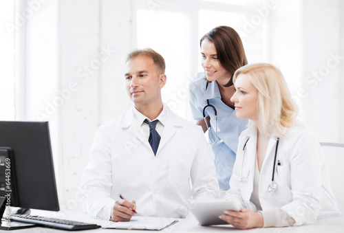 doctors looking at computer on meeting