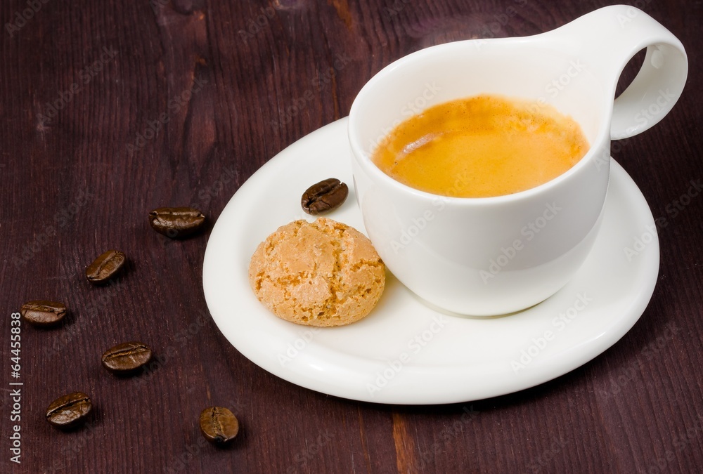cup of espresso coffee and biscuit near coffee beans cup of espresso coffee and biscuit near coffee beans
