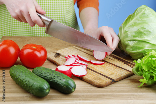 Female hands cutting celery
