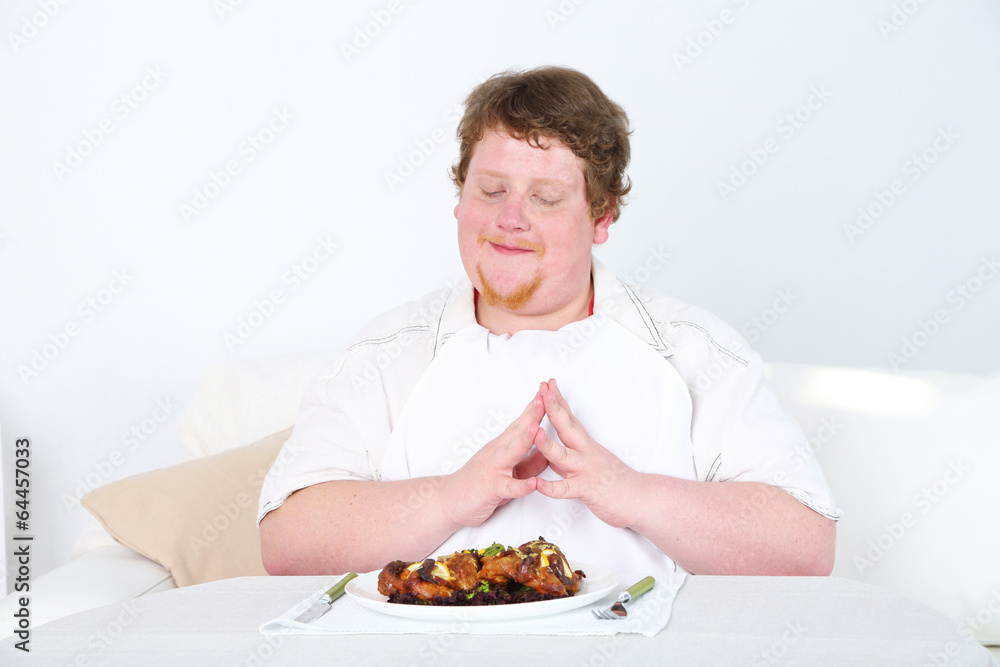 Tasty lunch for fat man, on home interior background Tasty lunch for fat man, on home interior background