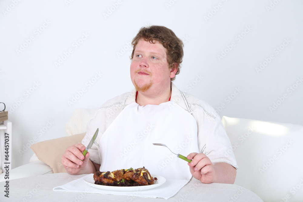 Tasty lunch for fat man, on home interior background