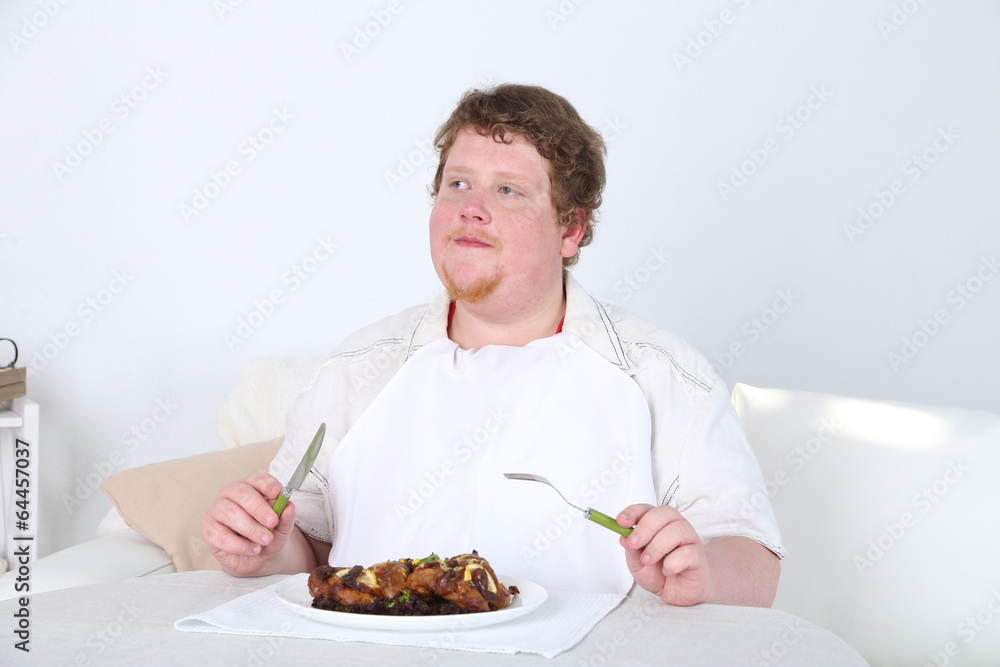 Tasty lunch for fat man, on home interior background Tasty lunch for fat man, on home interior background