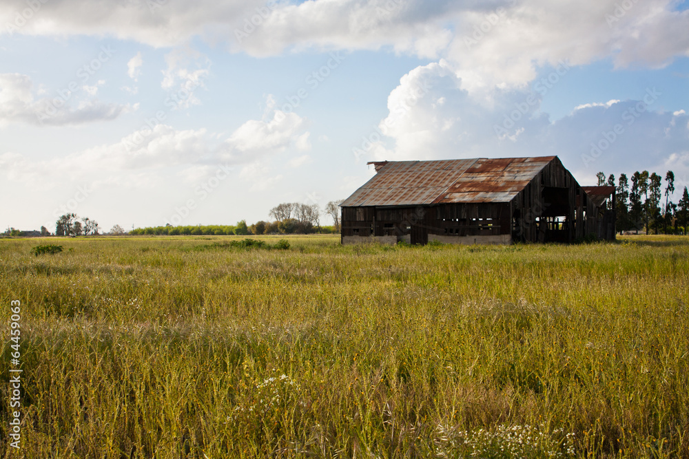 Old red barn with green field blue cloud sky Old red barn with green field blue cloud sky