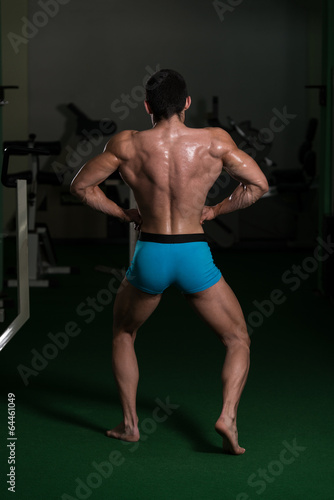 Bodybuilder Performing Back Lat Spread Poses