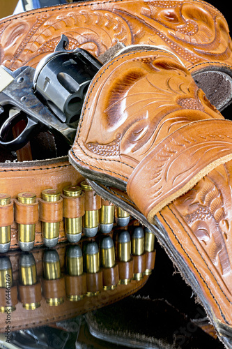 bullets and six shooter pistol in a holster photo