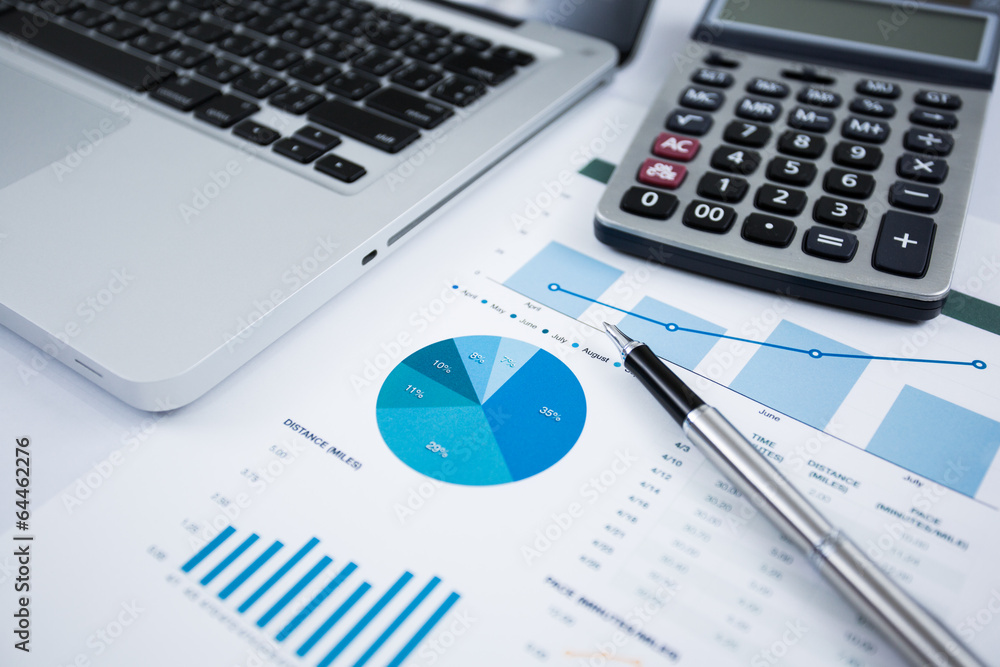 Businessman analyzing investment charts with laptop