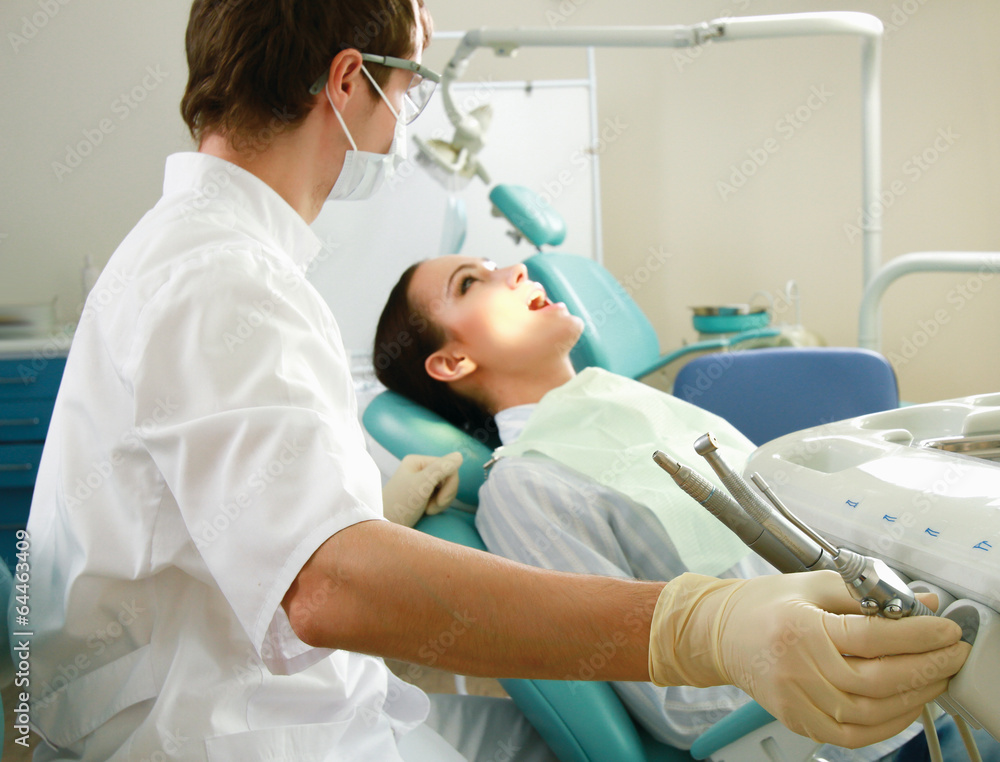 Young woman with dentist in a dental surgery. Young woman with dentist in a dental surgery.
