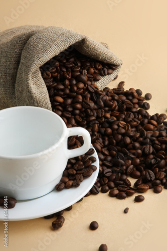 Cup from coffee on coffee grains.