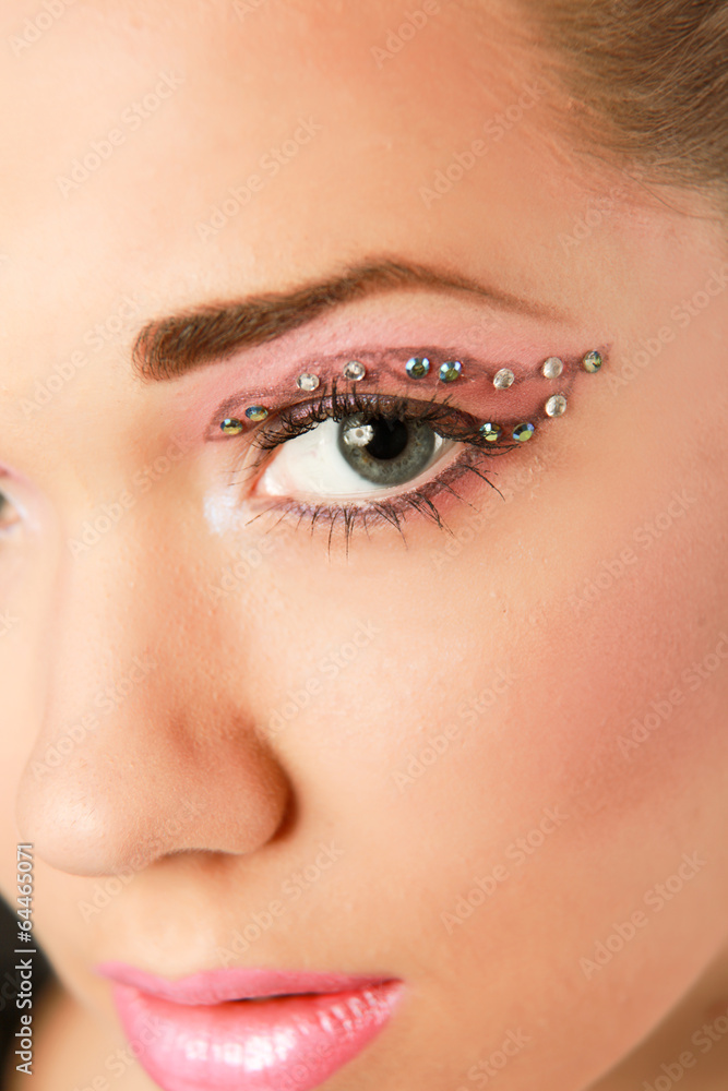 Woman eye with exotic style makeup.