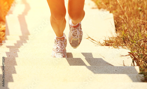 runner athlete running on mountain stone stairs photo