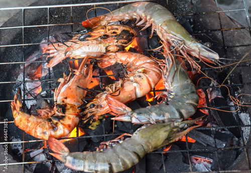 grilled shrimps with flames in background 