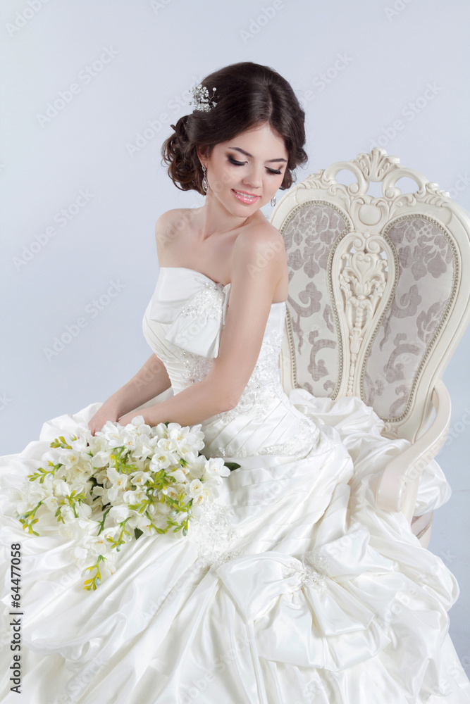 Beautiful charming bride in a luxurious dress. Happy brunette gi Beautiful charming bride in a luxurious dress. Happy brunette gi