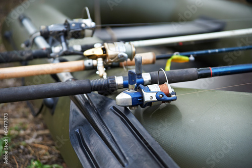 Three fishing spinning in a rubber boat