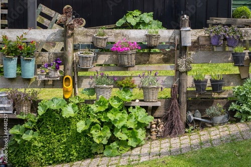 Colorful nostaligic fence with flowers and objects photo