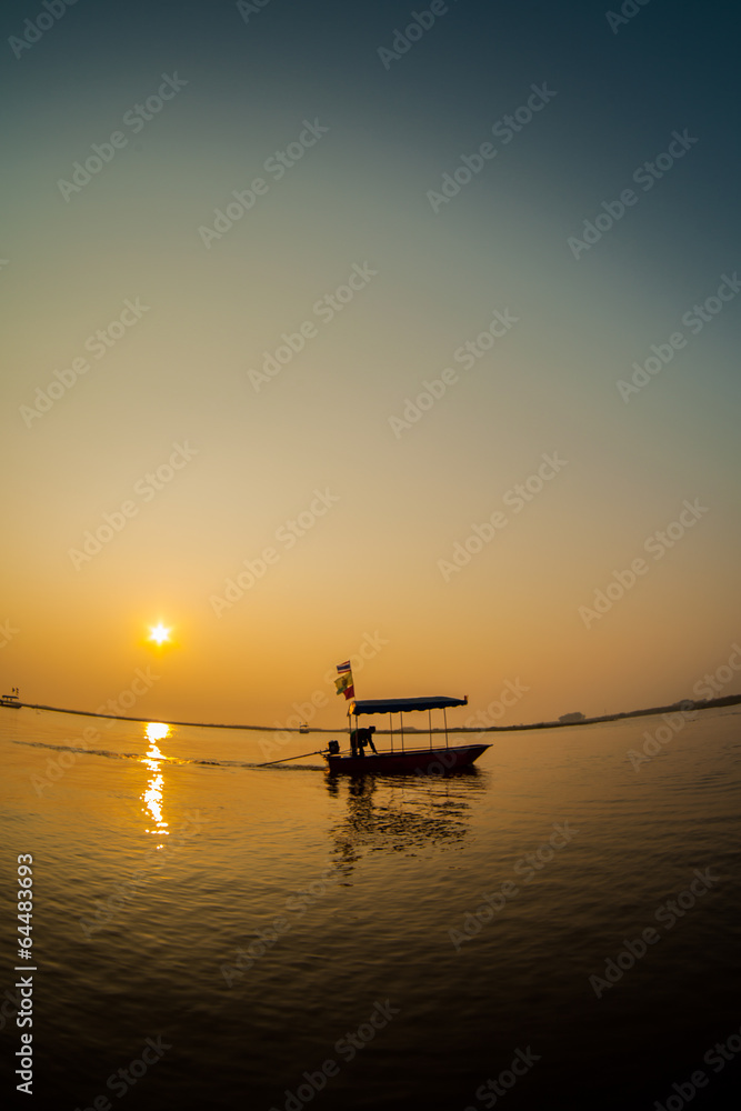 Silhouette of a fisherman on the sunset.