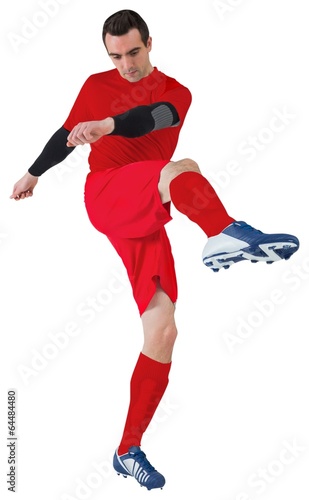 Football player in red kicking © WavebreakMediaMicro