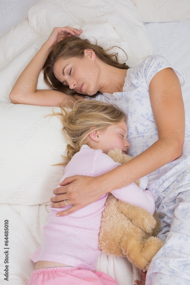 Girl and mother sleeping peacefully with stuffed toy in bed Girl and mother sleeping peacefully with stuffed toy in bed