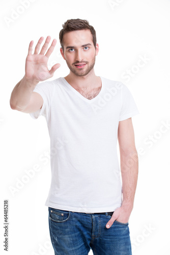 Young handsome man requiring stop with his hand.