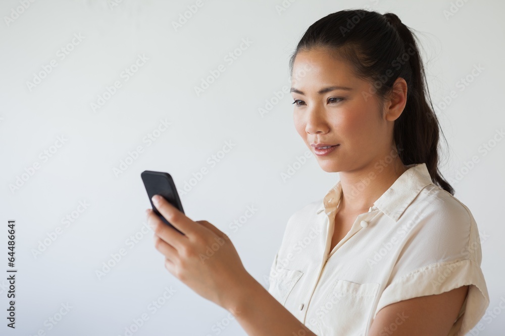 Casual businesswoman texting on the phone Casual businesswoman texting on the phone