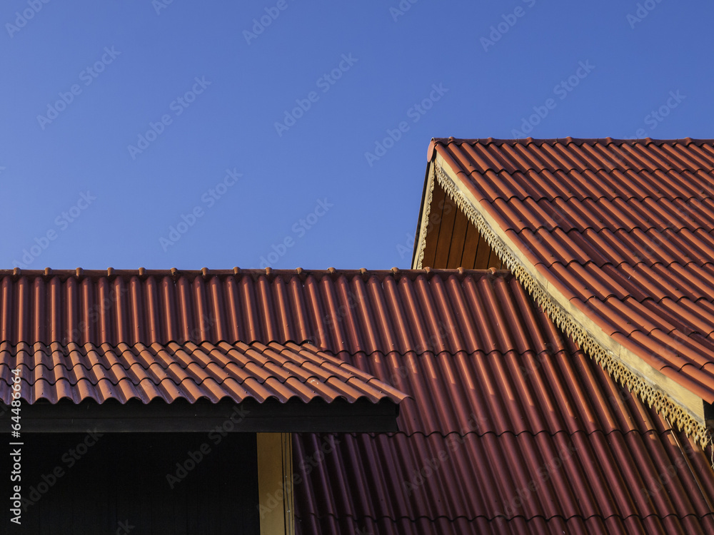 thai traditional roof tile against with blue sky