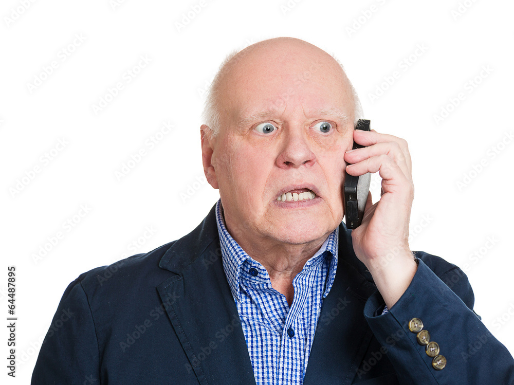 Bad news phone call. Senior man has unpleasant conversation Bad news phone call. Senior man has unpleasant conversation