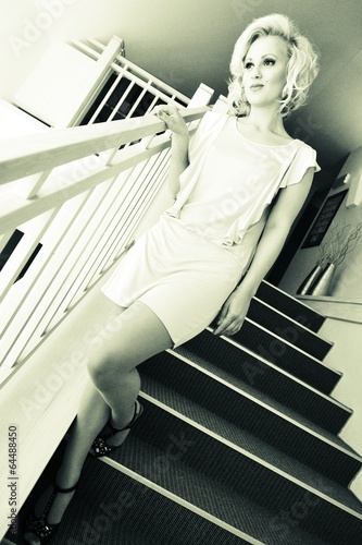Картината върху платно Sexy woman going down from staircase
