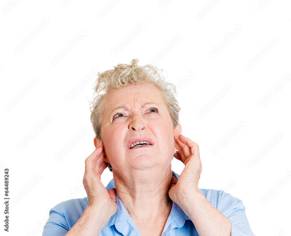 Loud noise upset stressed senior woman looking up Loud noise upset stressed senior woman looking up