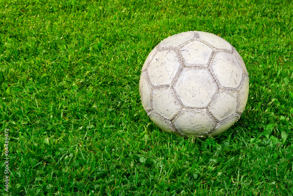 Fototapeta premium Used soccer ball on grass