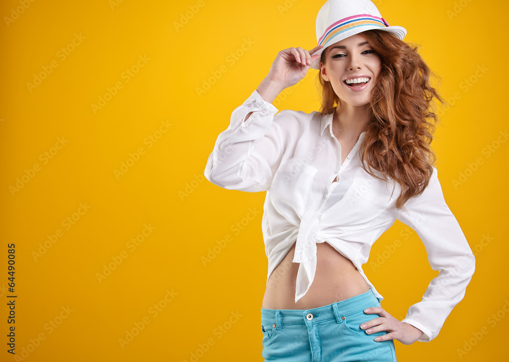 young happy girl in hat on yellow background young happy girl in hat on yellow background