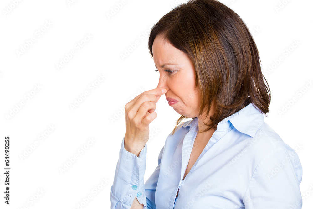 Woman pinches her nose, something stinks, unpleasant odor Woman pinches her nose, something stinks, unpleasant odor