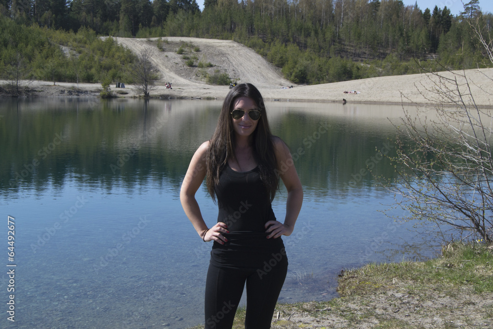 Satisfied woman by a beautiful lake (summer, trip, hike) Satisfied woman by a beautiful lake (summer, trip, hike)