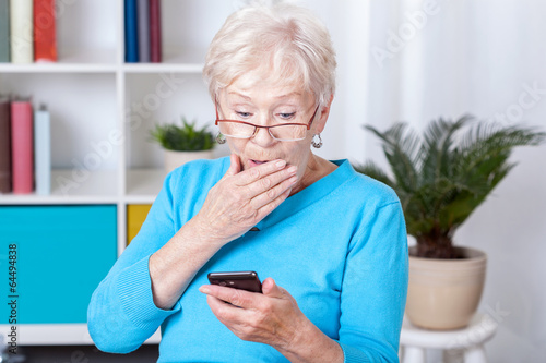 Elderly woman surprised by text message